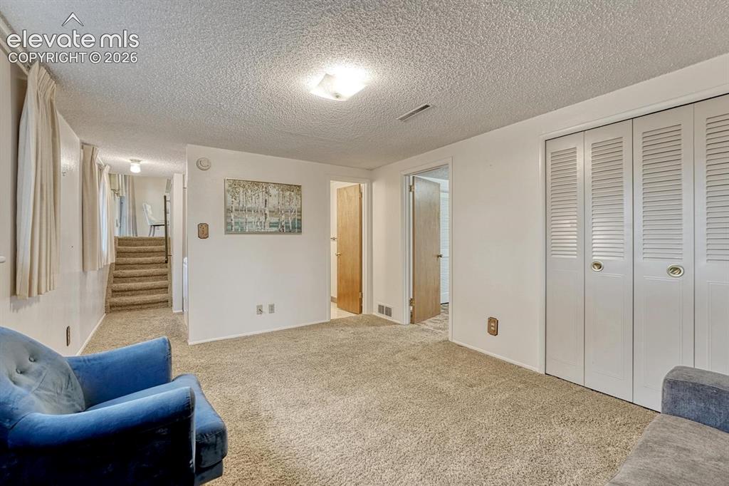 Image 14 of 36: lower level family room with extra storage