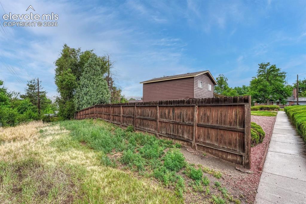 Image 20 of 36: View of easement with gate on fence for rv parking