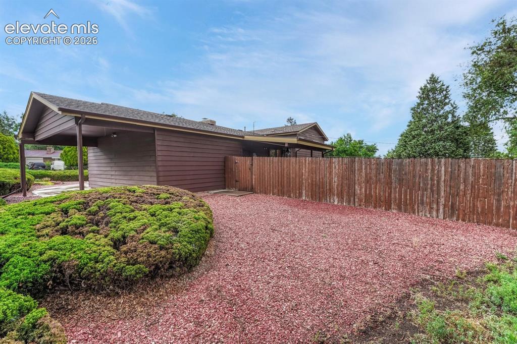Image 22 of 36: View of covered carport and side yard