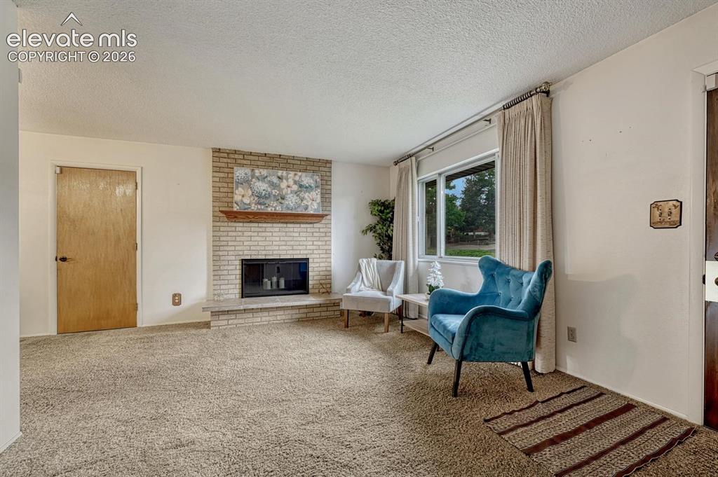 Image 9 of 36: living room with door to garage and entry