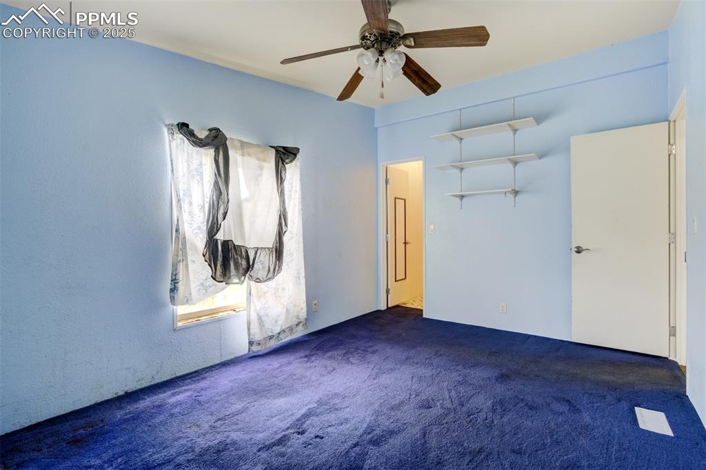 Image 28 of 49: Unfurnished bedroom featuring carpet flooring and a ceiling fan
