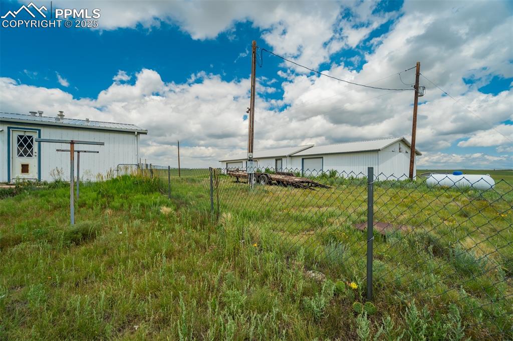 Image 32 of 49: View of yard with an outbuilding and a garage