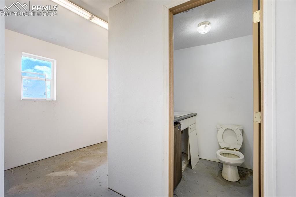 Image 39 of 49: Bathroom with concrete flooring and vanity
