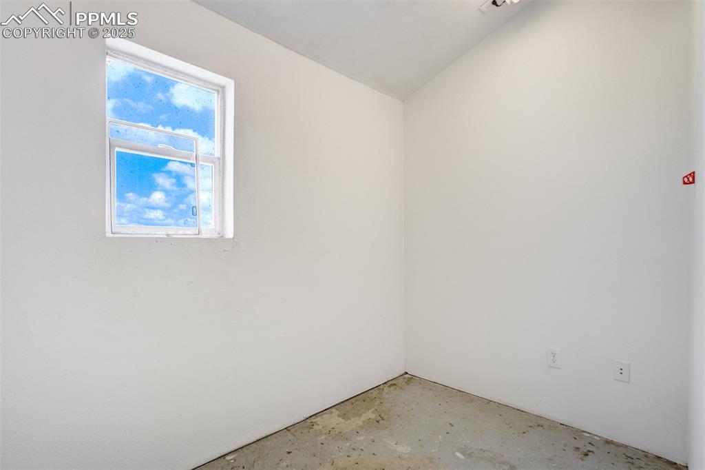 Image 41 of 49: Spare room featuring concrete flooring