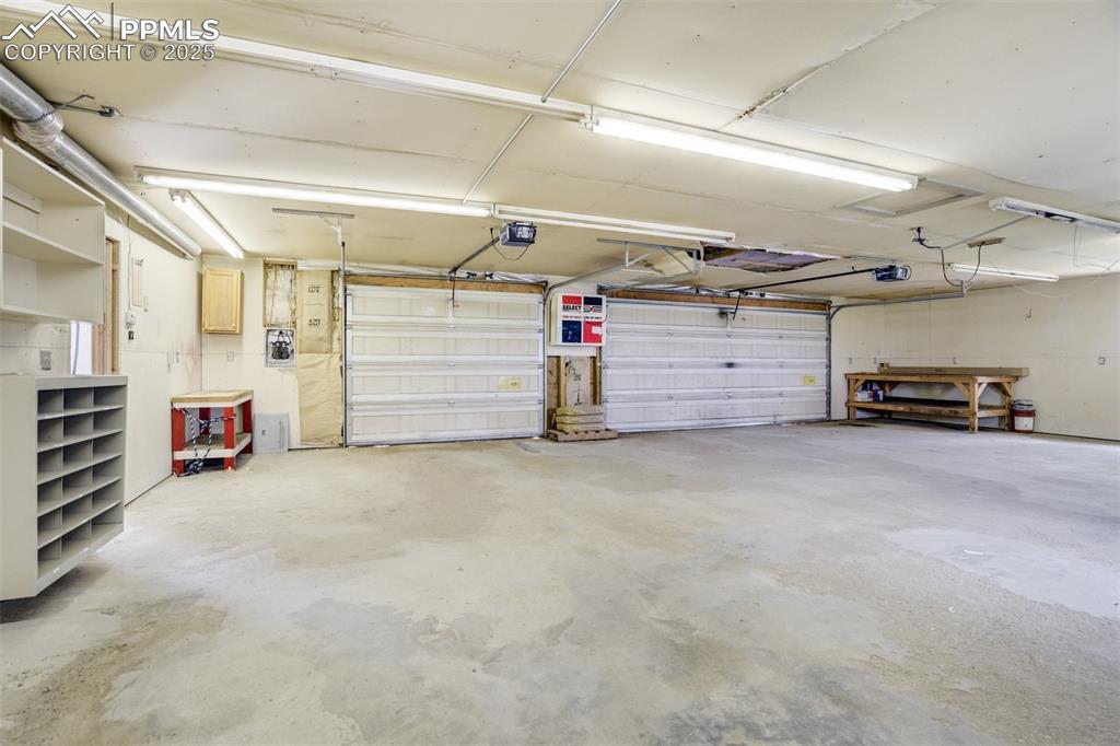 Image 43 of 49: Garage featuring a garage door opener