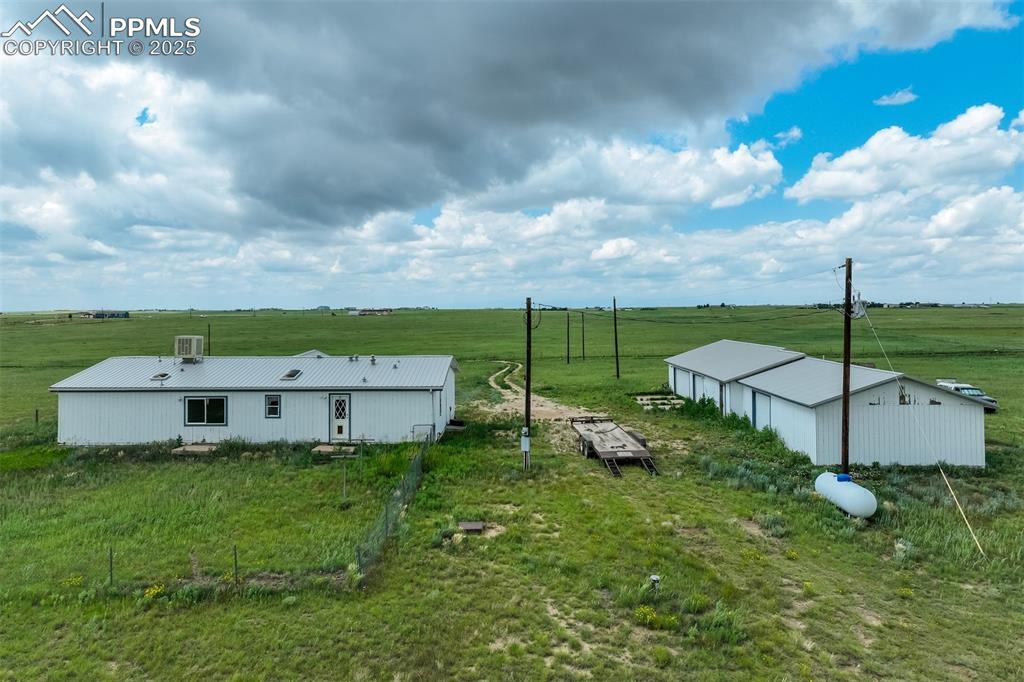 Image 5 of 49: View of yard with an outbuilding and a rural view