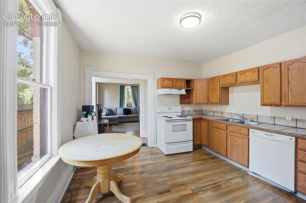 Image 11 of 43: Main Unit 1 - Kitchen, continued hardwood.
