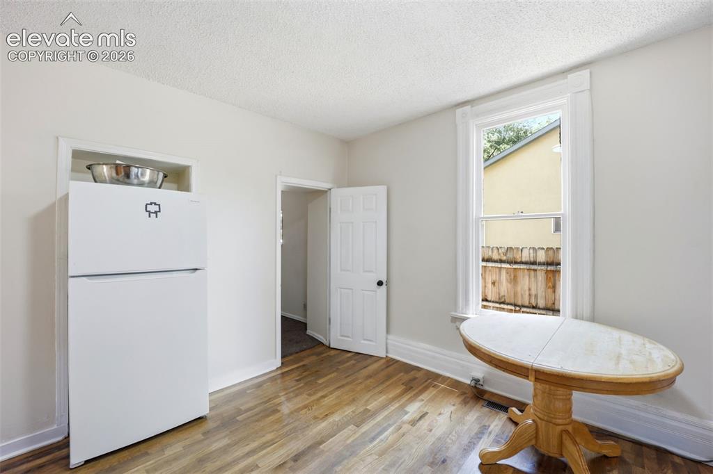 Image 12 of 43: Door to bedroom 2 off kitchen