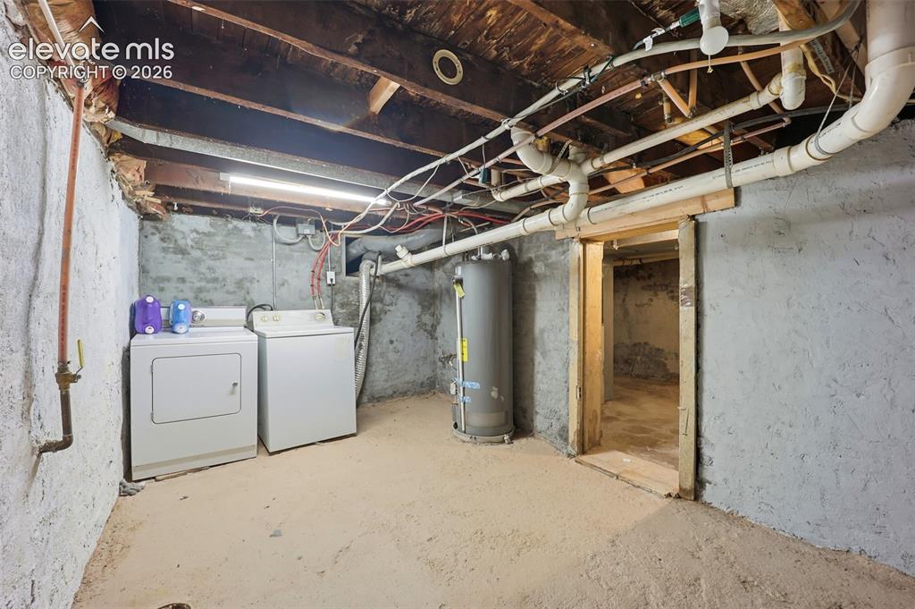 Image 19 of 43: Main Unit - Additional unfinished basement space including laundry
