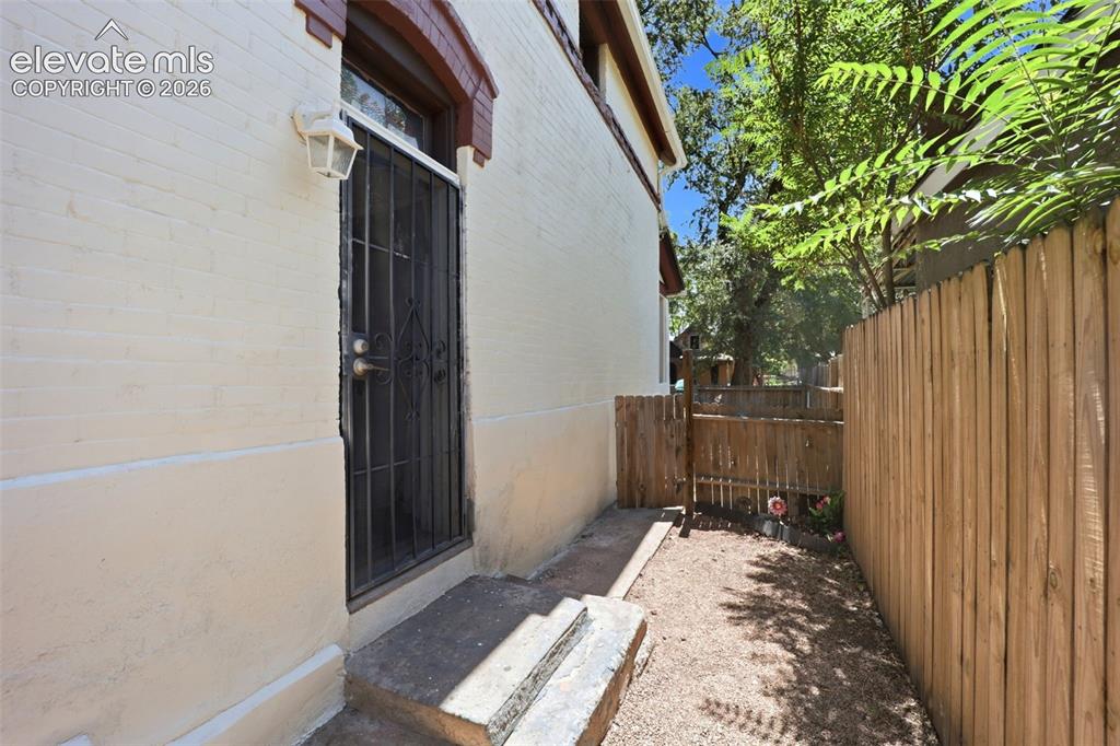 Image 23 of 43: Upper Unit - Private Entrace, gate to front