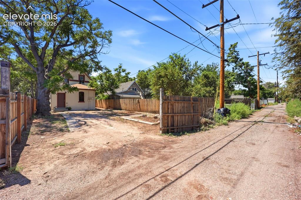 Image 39 of 43: Yard, Parking, and Alley Access with closeable gate
