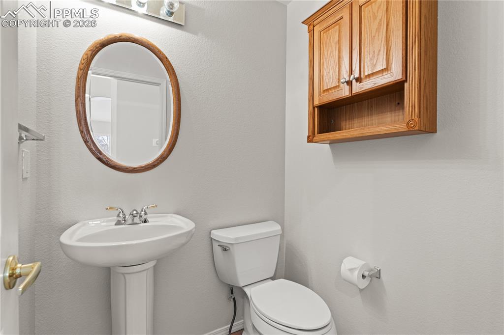 Image 17 of 39: Main level powder room.