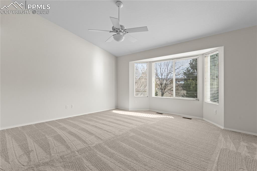 Image 19 of 39: The Primary Bedroom is located on the main level and is expansive.