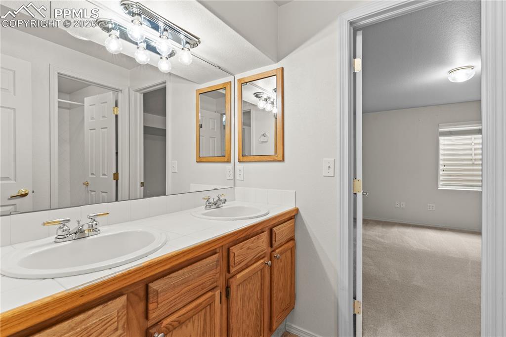 Image 33 of 39: A full bath is bright and airy in the basement.