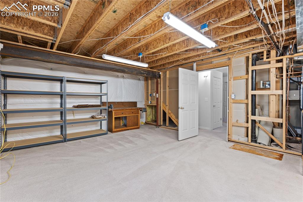 Image 36 of 39: Large basement storage room/workshop
