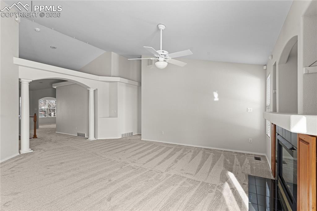 Image 5 of 39: The living room is the heart of the home with valuted ceilings, an abundanc