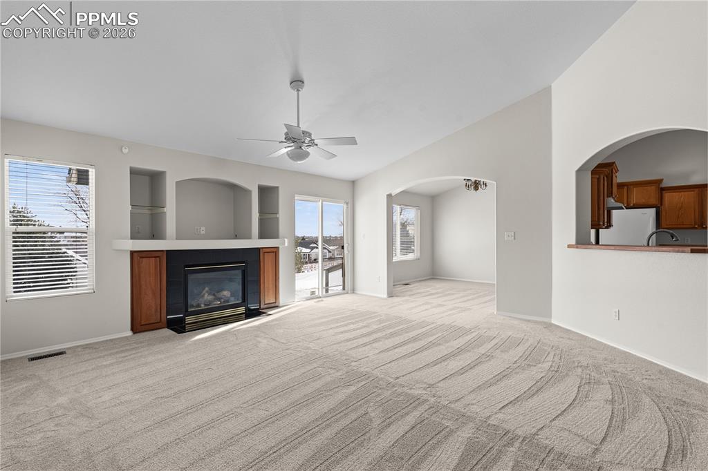 Image 6 of 39: Enjoy the oversized gas fireplace with access to both the eat in kitchen an