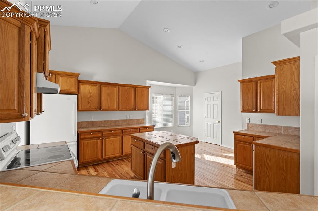Image 8 of 39: The Kitchen is huge with vaulted ceilings, tons of cabinetry, a dining spac