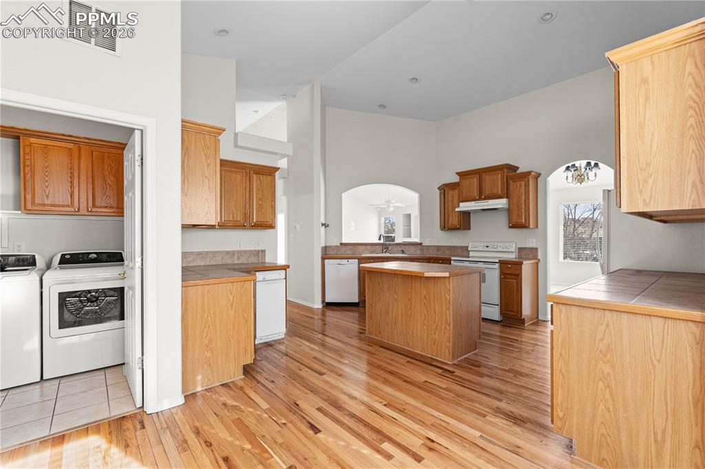 Image 9 of 39: The gorgeous hardwood floors make this space inviting and bright. The laun