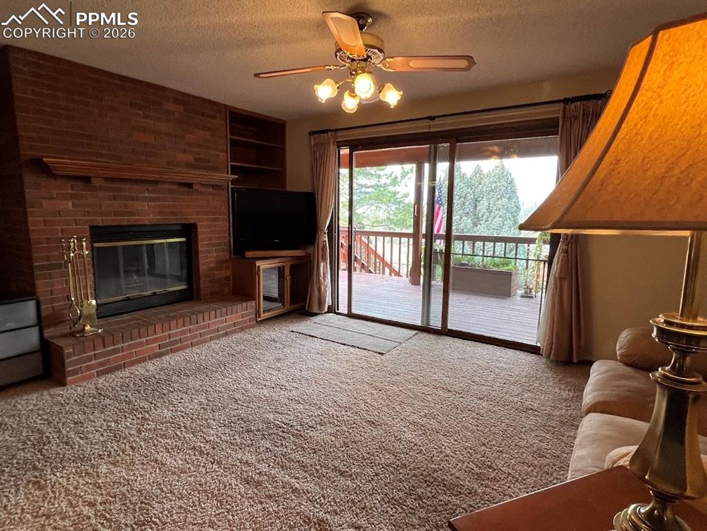 Image 10 of 40: Family Room, Gas Fireplace, access to covered deck