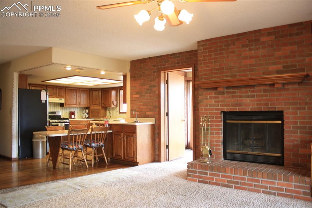 Image 11 of 40: Family Room View into Kitchen and Entrance to Sunroom