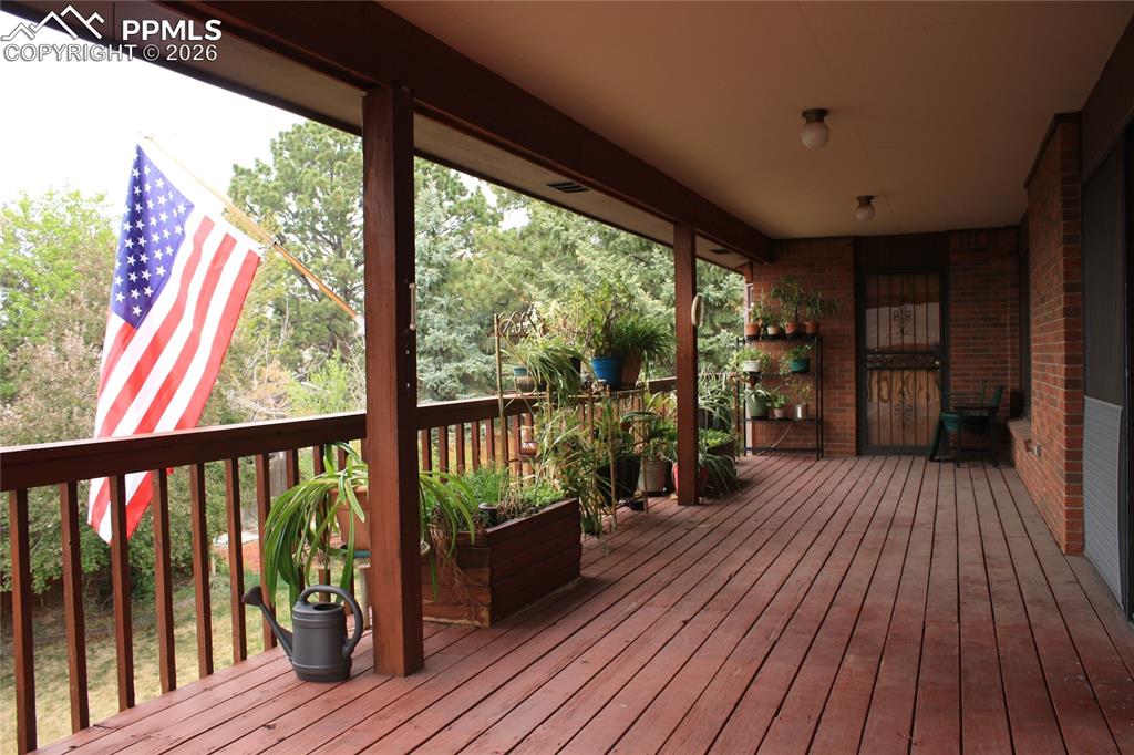 Image 37 of 40: Main level, covered deck with built in garden planter
