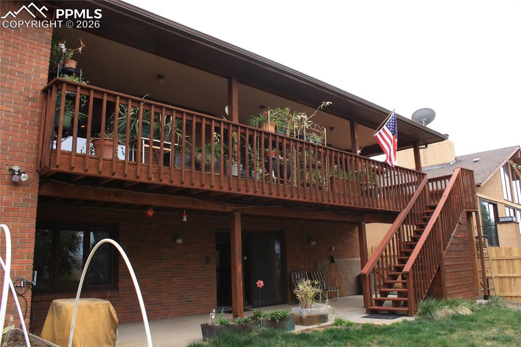 Image 39 of 40: Main level covered deck, lower level patio covered patio & hidden shed unde