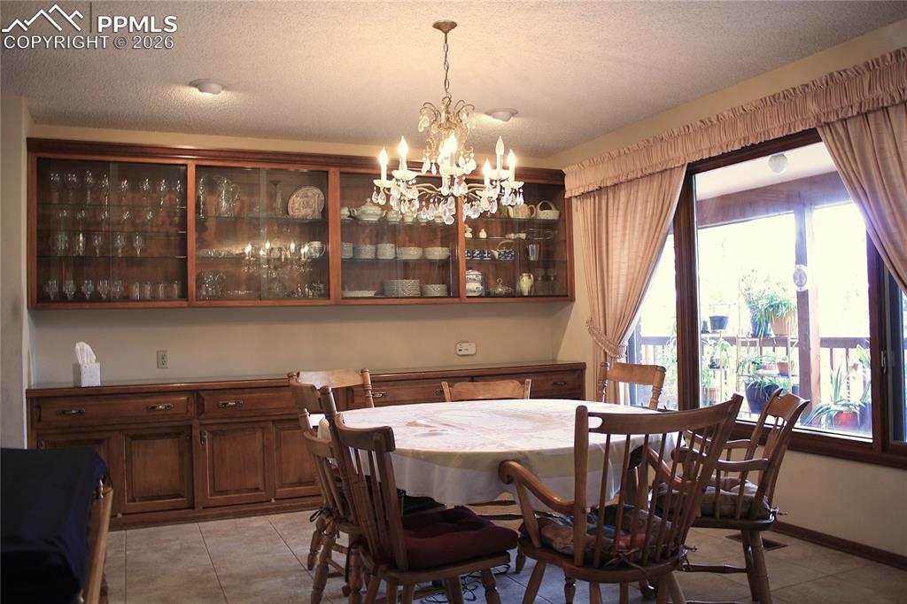Image 7 of 40: Dining Room with Built in Glass front cabinets