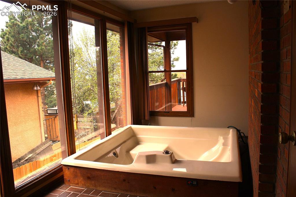 Image 8 of 40: Sun Room with Hot Tub