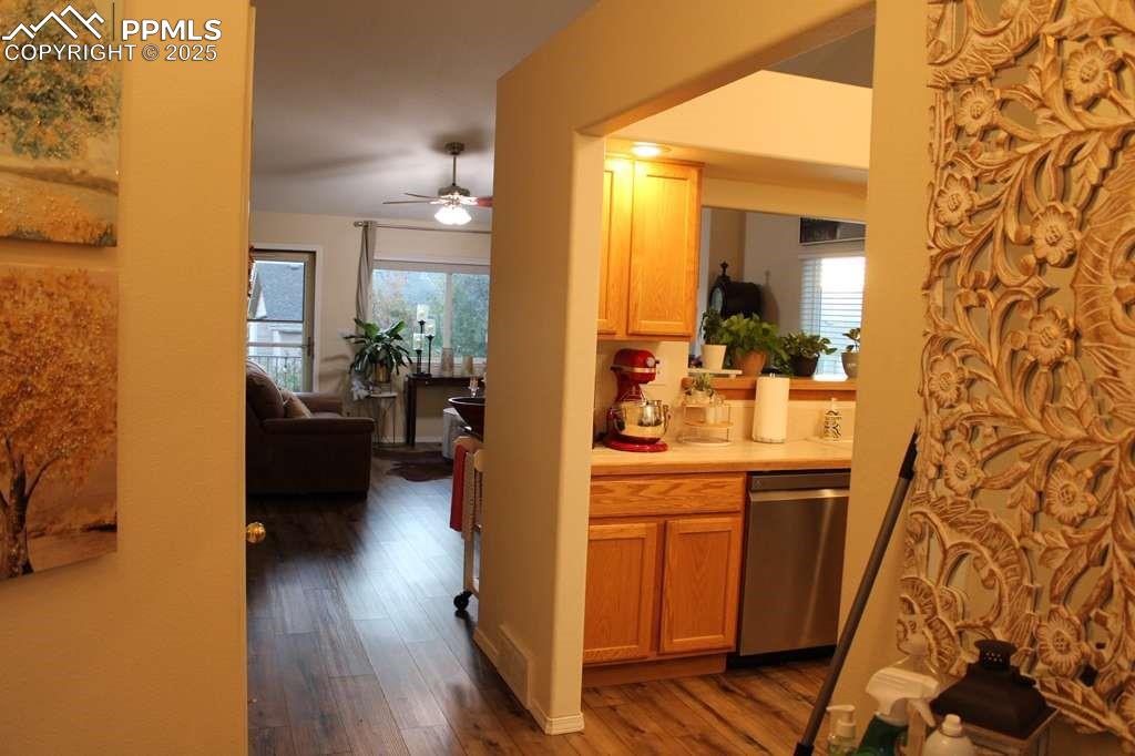 Image 5 of 30: Kitchen featuring light countertops, dark wood-style floors, stainless stee