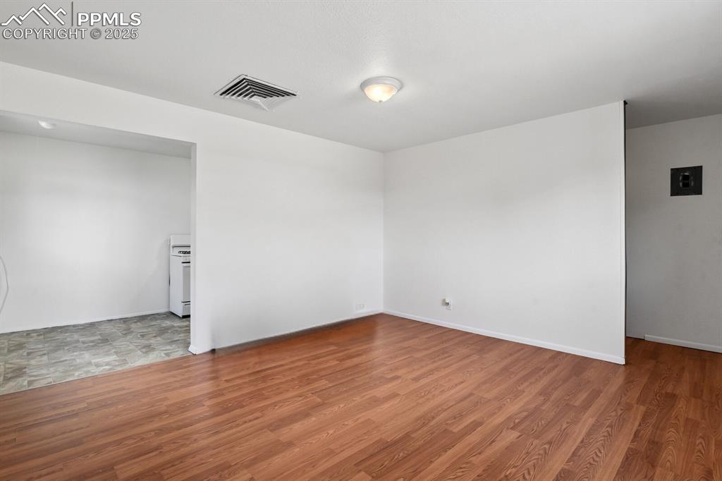 Image 14 of 33: Empty room with wood finished floors and baseboards