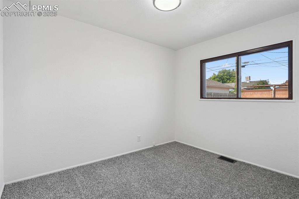 Image 18 of 33: Carpeted spare room with baseboards