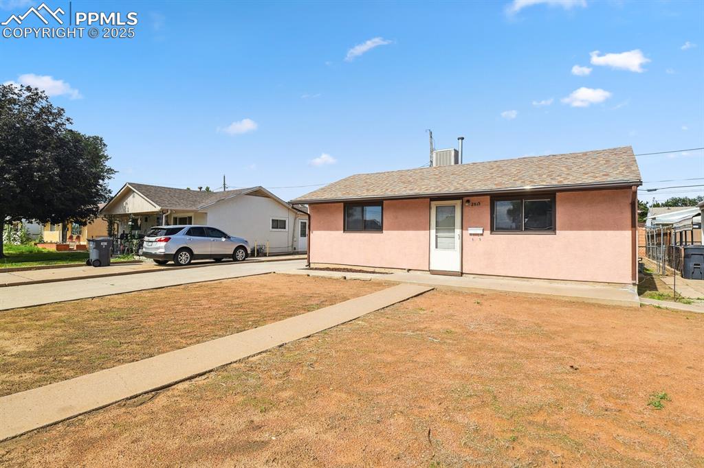 Image 2 of 33: Ranch-style house featuring a front yard, roof with shingles, and stucco si