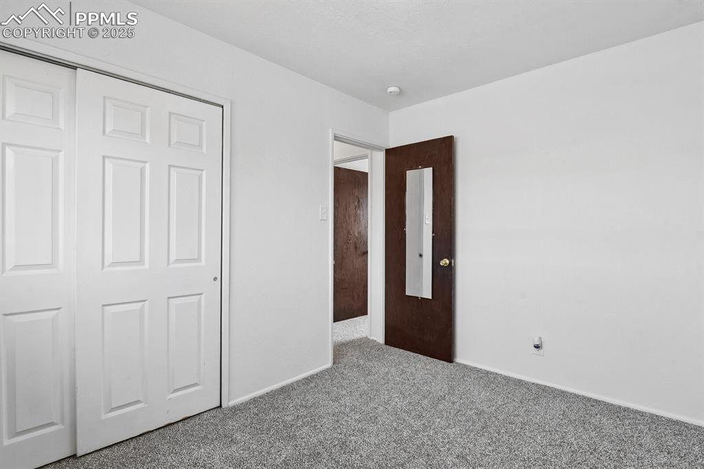 Image 20 of 33: Unfurnished bedroom featuring carpet and a closet