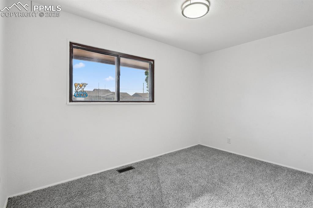 Image 22 of 33: Empty room featuring carpet floors and baseboards
