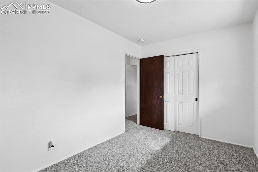 Image 24 of 33: Unfurnished bedroom featuring carpet and a closet