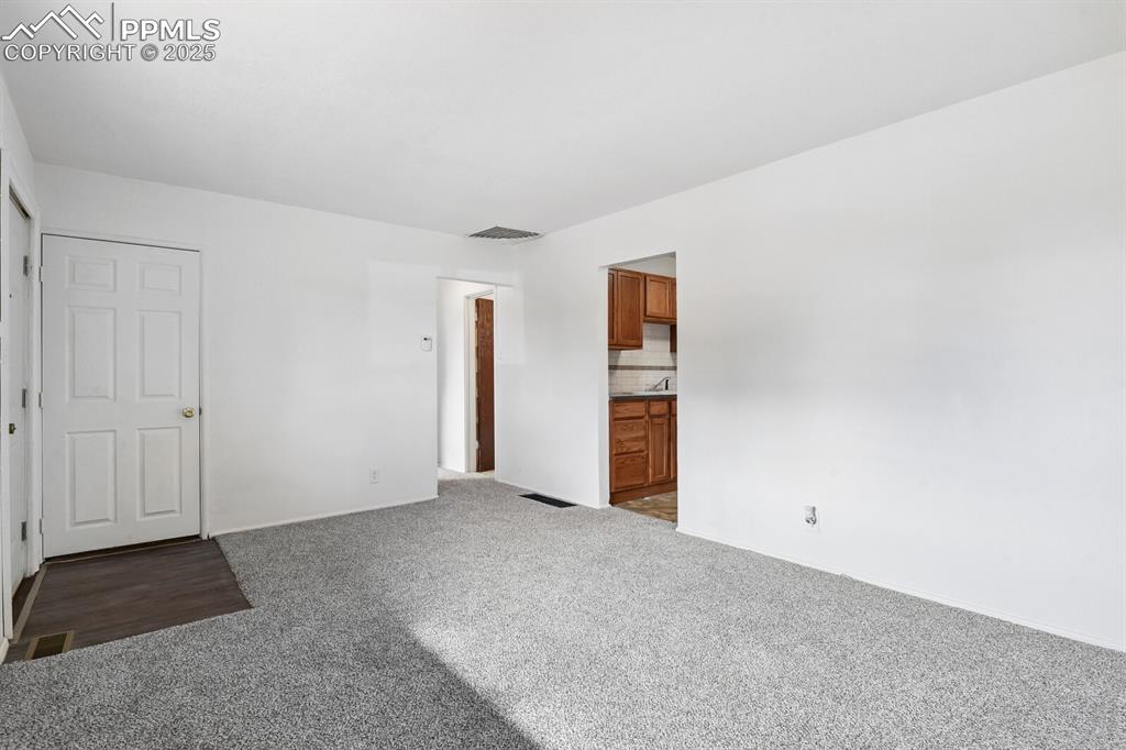 Image 7 of 33: Unfurnished bedroom with carpet flooring and ensuite bath