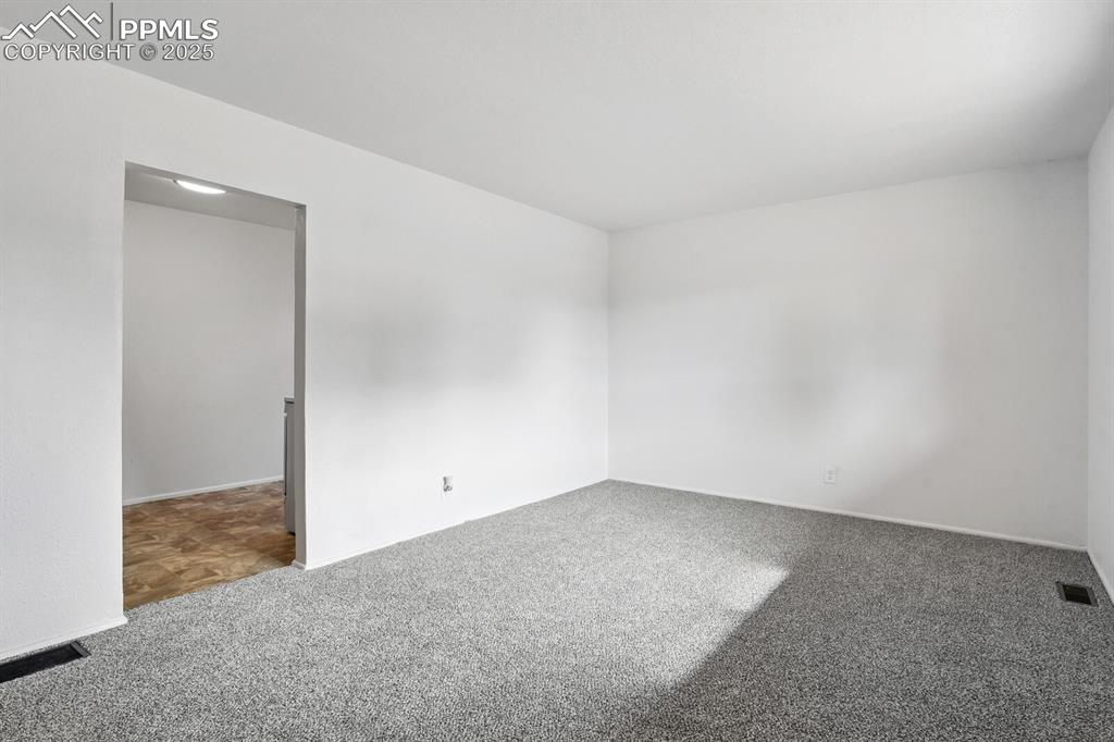 Image 8 of 33: Unfurnished room featuring carpet and baseboards