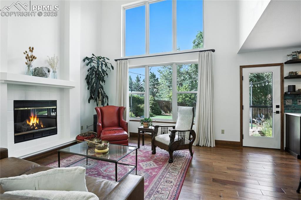 Image 15 of 50: Living area featuring a high ceiling, healthy amount of natural light, a ti