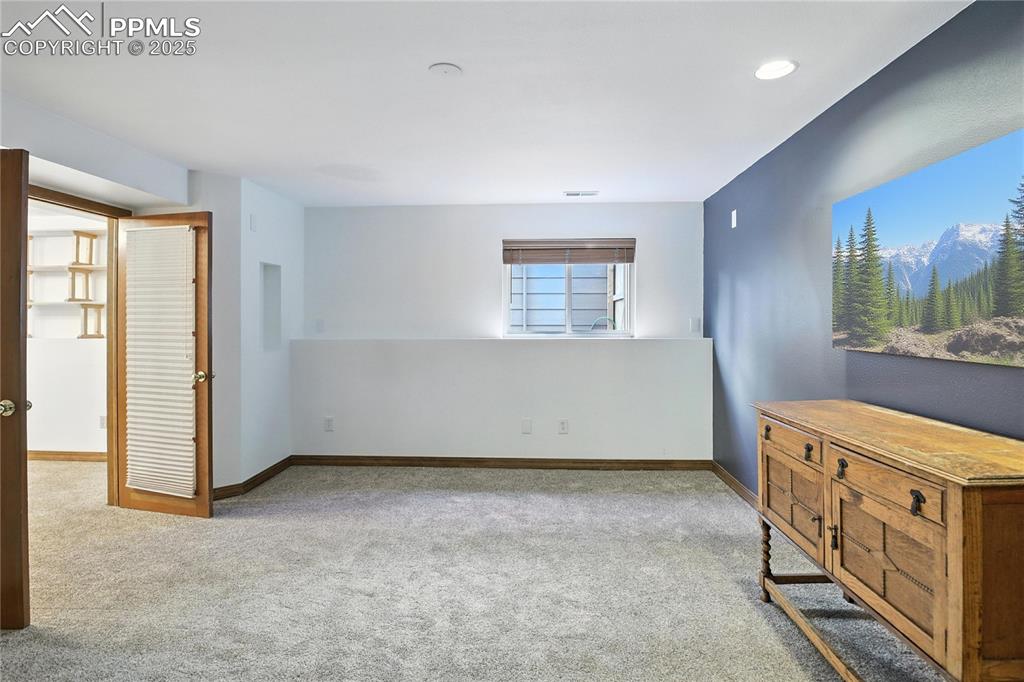 Image 29 of 50: Carpeted bedroom with baseboards