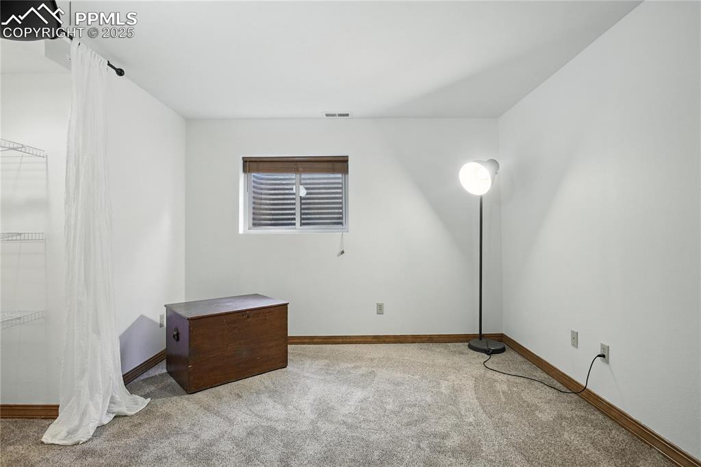 Image 33 of 50: Unfurnished bedroom featuring carpet flooring and baseboards