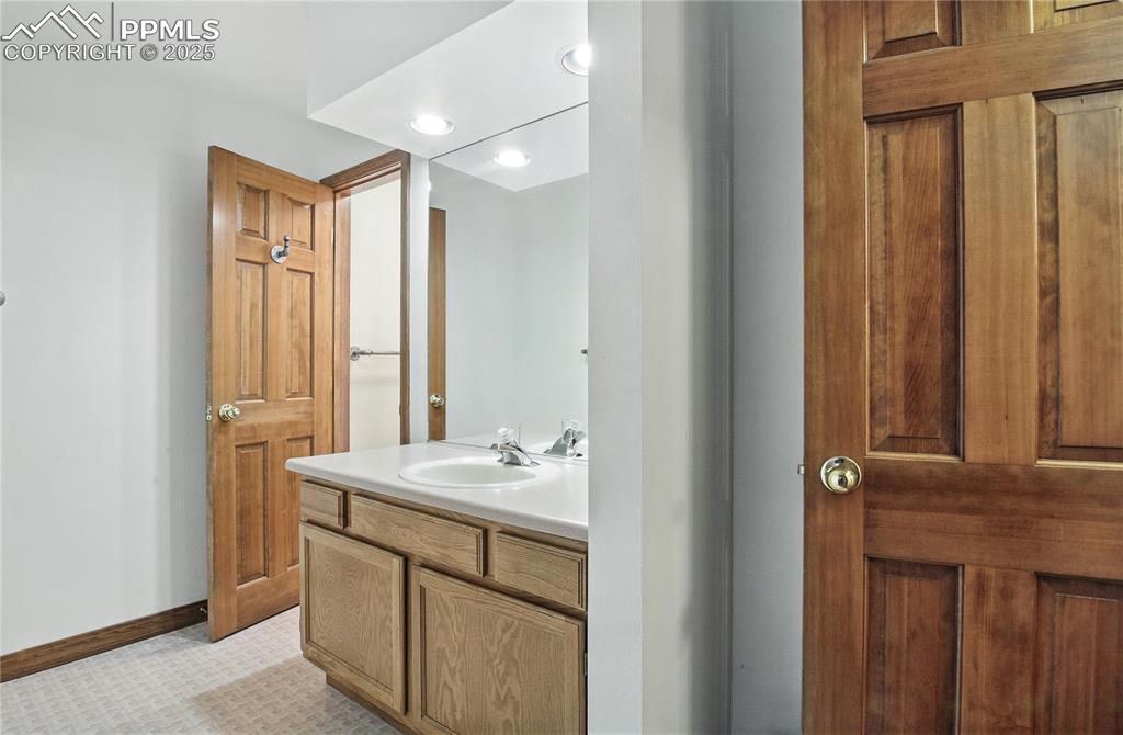 Image 34 of 50: Bathroom with vanity and baseboards