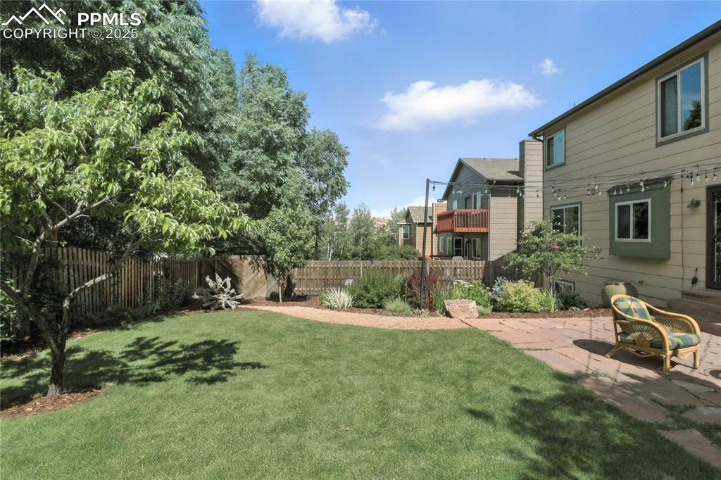 Image 40 of 50: View of yard with a patio area