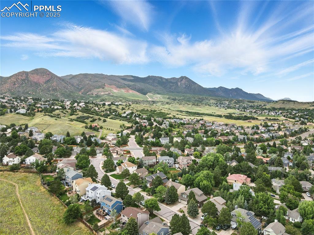 Image 45 of 50: Aerial view of residential area with a mountain backdrop