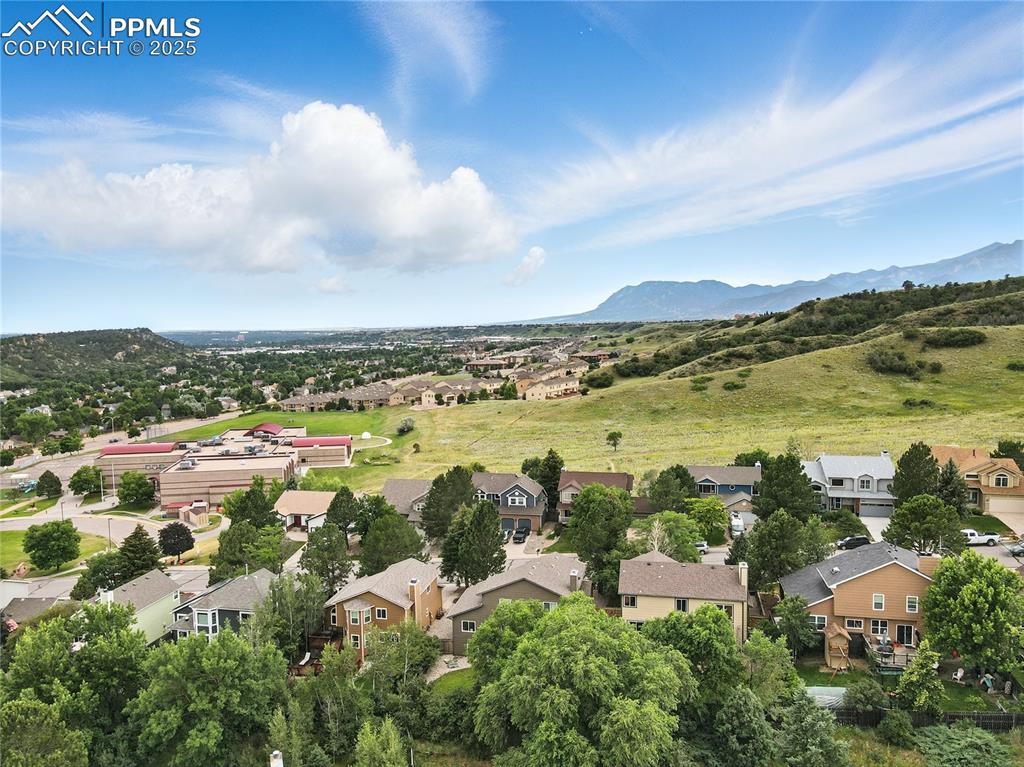 Image 47 of 50: Aerial perspective of suburban area with a mountain backdrop