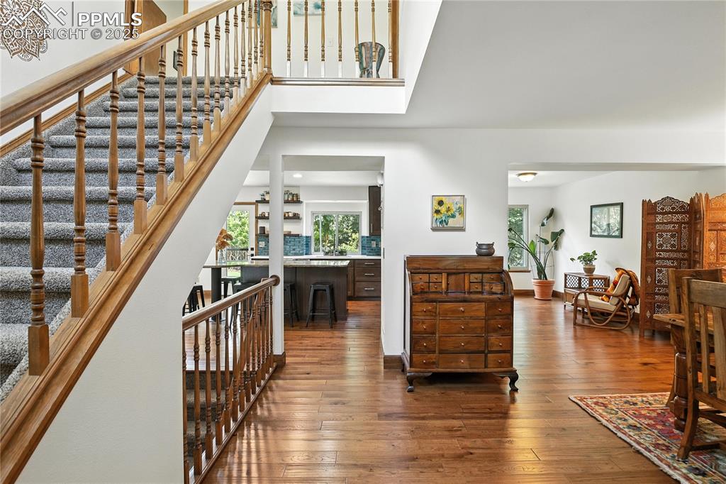 Image 6 of 50: Hall with wood-type flooring and stairway