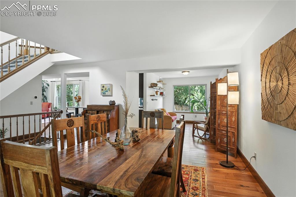 Image 7 of 50: Dining area with healthy amount of natural light, hardwood / wood-style flo