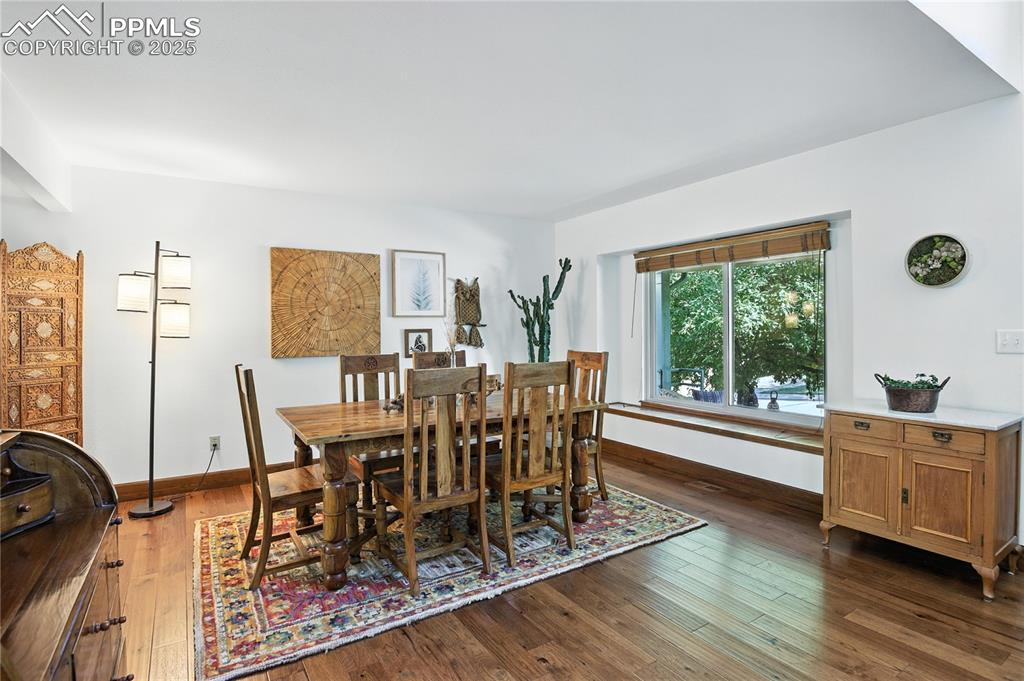 Image 8 of 50: Dining room featuring dark wood finished floors