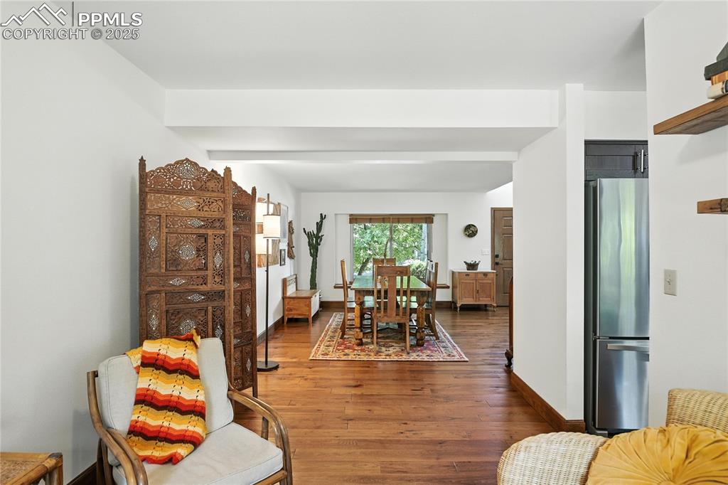Image 9 of 50: Dining area with dark wood-type flooring and baseboards