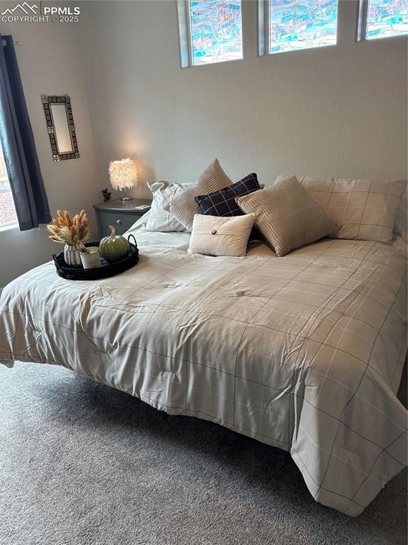 Image 13 of 31: Master bedroom with decorative transom windows allowing more natural light